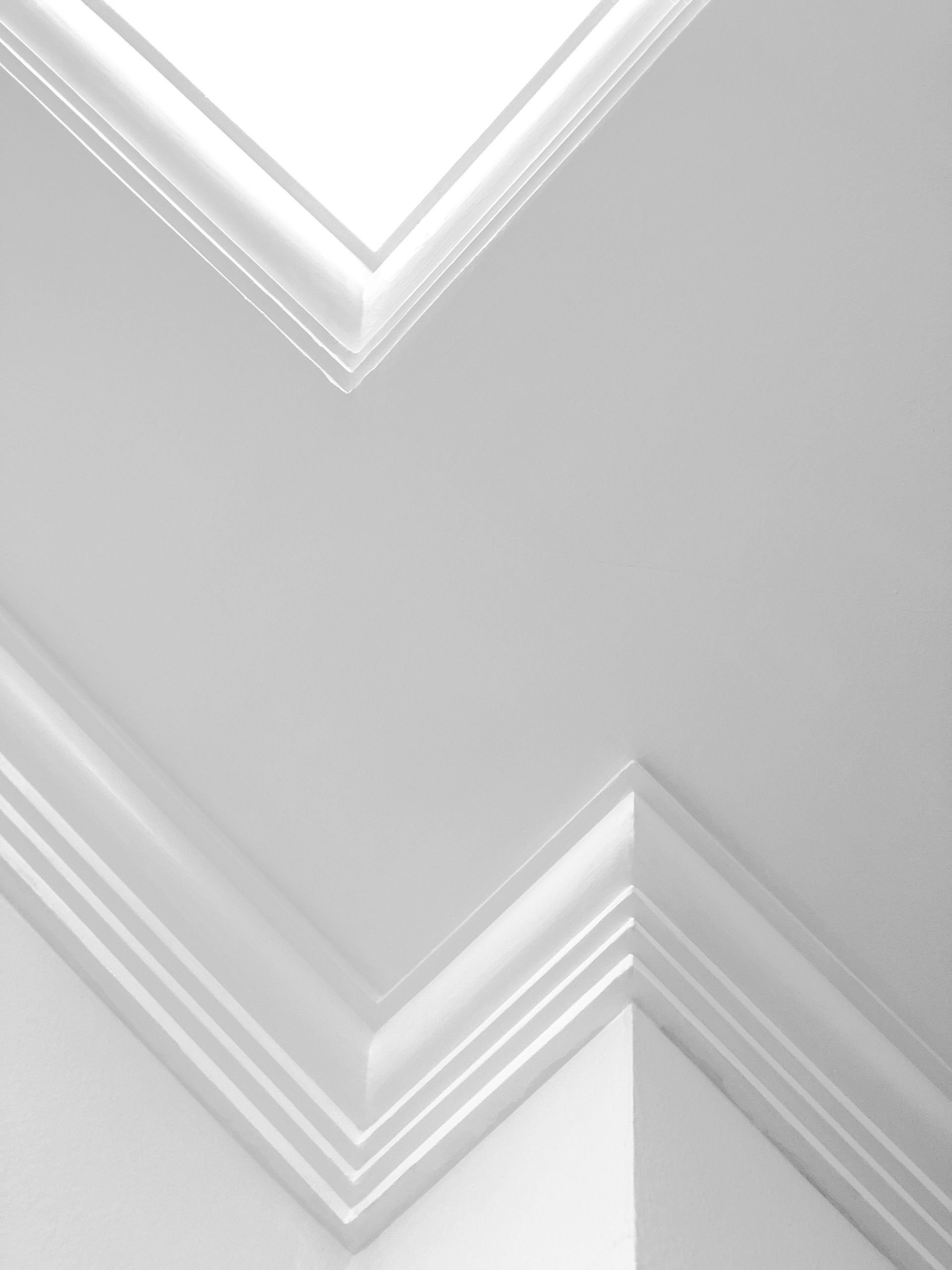 White modern ceiling with geometric shapes and clean lines, showcasing contemporary design.